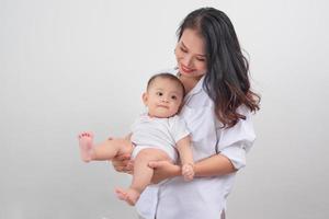 en sécurité dans les bras de sa mère. mère et sa petite fille à la maison. photo