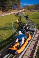 croatie, 2022 - jeune mère et fils conduisant des montagnes russes alpines photo