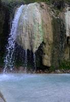 Verser de l'eau sur des gisements minéraux à une source chaude photo