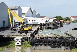 deux pelleteuses jaunes sur quai et barges photo