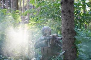 Soldat en action visant l'optique de visée laser de l'arme photo