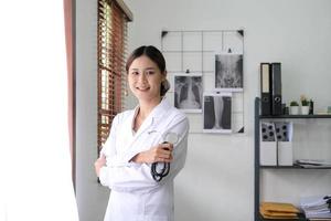 gros plan sur une femme médecin asiatique debout bras croisés avec stéthoscope. concept médical et de soins de santé photo