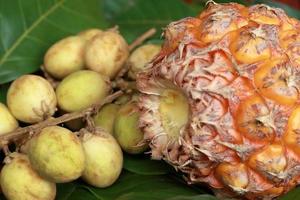 beaucoup de fruits mûrs avec ananas mûr sur fond de bois photo