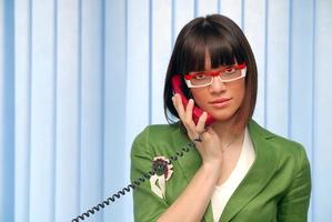 .femme d'affaires en costume vert parlant par téléphone portable photo