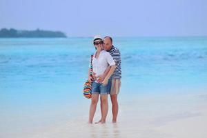 heureux jeune couple s'amuser sur la plage photo