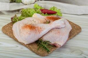 cuisse de poulet sur planche de bois et fond en bois photo