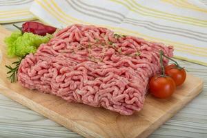 viande hachée sur planche de bois et fond en bois photo