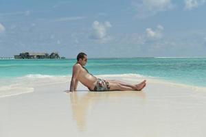 belle jeune femme sur la plage s'amuser et se détendre photo