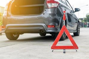 signe de voiture cassée sur une route avec une voiture en panne photo