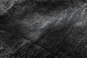 fond en cuir noir véritable, motif, texture. photo