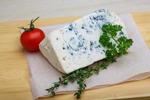 Fromage bleu sur planche de bois et fond de bois photo