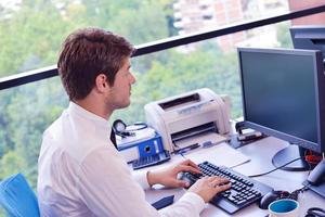 heureux jeune homme d'affaires au bureau photo