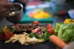 assiette de viande de steak de finition à la main du chef photo