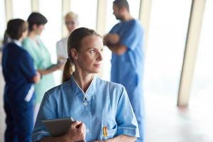 femme médecin avec tablette devant l'équipe photo