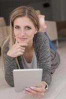 les jeunes femmes ont utilisé un ordinateur tablette sur le sol photo