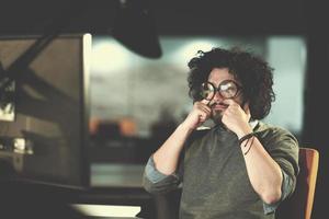 homme travaillant sur ordinateur dans un bureau de démarrage sombre photo