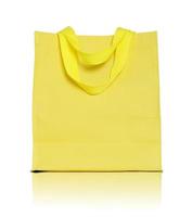 Sac shopping en toile jaune sur fond blanc photo