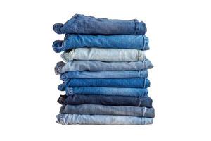 Pile de jeans bleu denim pile isolé sur fond blanc photo