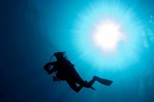 silhouette de plongeur dans la mer bleue photo