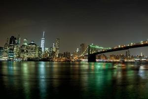 vue de nuit sur le paysage urbain de new york depuis brooklyn photo