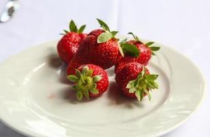 fraise fraîche sur la plaque et fond blanc photo