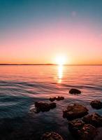 roches sur l'eau avec un ciel coloré photo