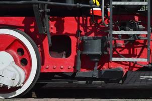 roues de la vieille locomotive à vapeur noire de l'époque soviétique. le côté de la locomotive avec des éléments de la technologie rotative des anciens trains photo