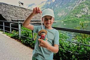 garçon joue avec une poupée en bois à hallstatt, en autriche. photo