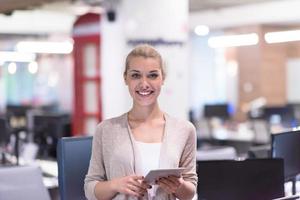 femme d'affaires utilisant une tablette numérique devant le bureau de démarrage photo