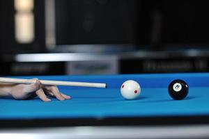 jeune homme joue au jeu de billard pro photo