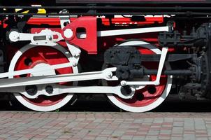 roues de la vieille locomotive à vapeur noire de l'époque soviétique. le côté de la locomotive avec des éléments de la technologie rotative des anciens trains photo