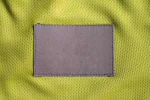 Patch d'étiquette de vêtements d'entretien du linge sur la texture de sport de jersey de tissu de polyester photo