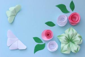 fond de papier origami avec deux papillons, fleurs et feuilles. avec place pour le texte. composition d'origami. artisanat en papier photo