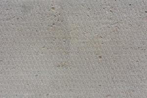 texture et arrière-plan harmonieux de l'ancienne surface de béton plat et sec avec motif en losange et signes d'usure légère photo