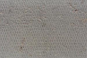 ancienne texture de béton plat et sec sans couture avec motif en losange et légers signes d'érosion photo