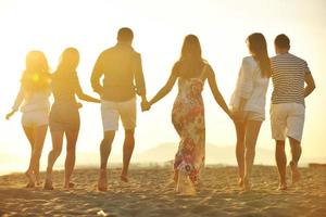 groupe de jeunes heureux s'amuser sur la plage photo