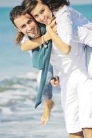 heureux jeune couple s'amuser sur la belle plage photo