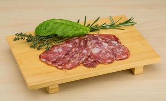 salami sur planche de bois et fond en bois photo