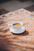 verre de boisson chaude à l'heure du petit-déjeuner, peut être du café ou du cacao. avec une ambiance décontractée. se sentir détendu et au chaud. photo