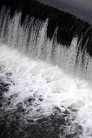 une image de l'eau qui coule. le barrage est conçu pour réguler le niveau d'eau dans les rivières de la ville et pour fournir de l'eau technique aux objets industriels photo