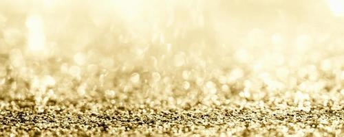 paillettes d'or abstraites scintillantes floues avec fond bokeh photo