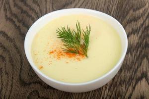 soupe au fromage dans un bol sur fond de bois photo