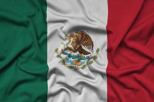 le drapeau du mexique est représenté sur un tissu de sport avec de nombreux plis. bannière de l'équipe sportive photo