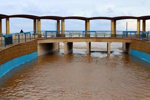 hautes berges en béton d'une rivière orageuse. photo