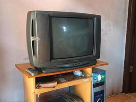 objets anciens sur un bureau d'ordinateur. une télévision à tube pointu, un ancien processeur d'ordinateur et une radio polytron et un lecteur de cassettes. photo