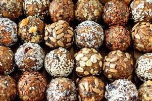 boules d'énergie crues saines avec cacao, noix de coco, sésame et graines. fond de nourriture. photo