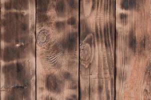 la texture du mur en bois brûlé. mur de longues planches de bois orange lisse avec une texture noire spécifique de friture photo