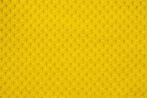 tissu de vêtements de sport jaune maillot de football texture jersey gros plan photo