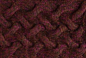 texture de pull foncé tricoté lisse avec motif. vue de dessus, gros plan. texture de tissu de laine ou de coton à tricoter à la main. arrière-plan de motifs de tricot avec un grand câble de tresse vertical. photo