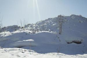 montagne de neige au soleil. rayons dans la neige. photo